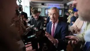 PA Media Nigel Farage speaks to reporters